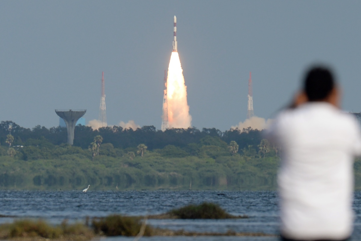 spectator watches rocket launch in India