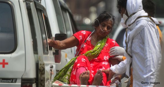 woman in India suffering from Covid-19 on a stretcher